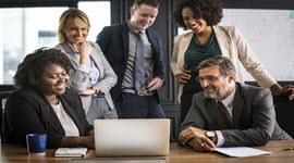 A group of business people looking at a laptop screen