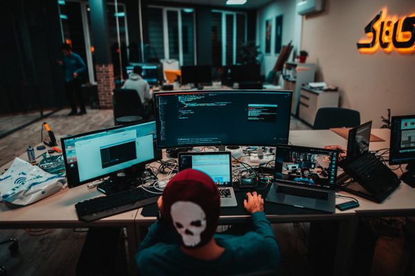 man with a lot of computer screens